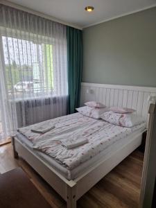 Łóżko lub łóżka w pokoju w obiekcie AGIS Pokoje Gościnne
