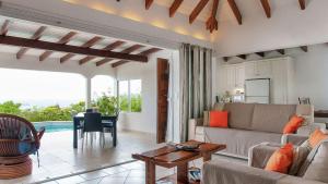 a living room with a couch and a table at Rustic Romantic Villa with Lovely Ocean Views in Marigot