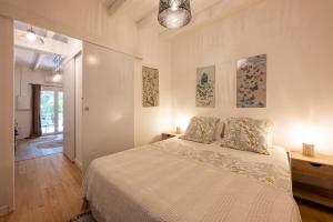 a white bedroom with a bed with two pillows at La ferme Saint-Antoine in Gassin +79 photos