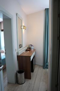 a bathroom with a vanity with a mirror and a sink at Sardinia Otel in Amasra +60 photos