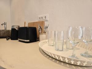 a group of wine glasses sitting on a counter at Pension Zoi in Kolymbia +27 photos
