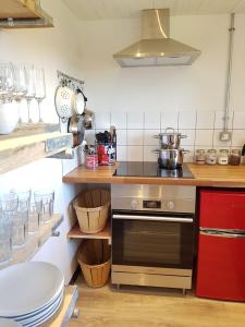 a kitchen with a stove top oven in a kitchen at Milking Shed Cottage in Narberth