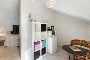 a living room with a white refrigerator and a table at Pardelo in Los Menores