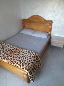 a bed in a room with a leopard print blanket at nice appartement near to sea and forest in Tangier in Hajreien