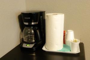 a coffee maker and a roll of toilet paper on a counter at Lakeview Room 2 Queens - 23 in Mead +22 photos