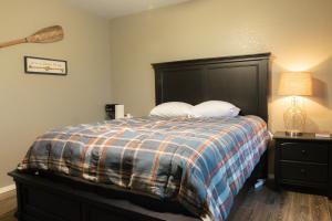 a bedroom with a bed with a large black headboard at Lakeview Room 2 Queens - 23 in Mead