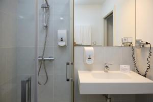 a bathroom with a sink and a shower at Hotel Vigo Plaza in Vigo +27 photos