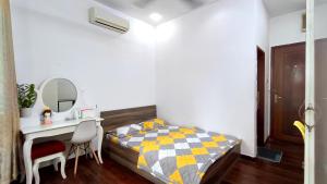 a bedroom with a bed and a desk and a mirror at Studio luxury District 10 - A paradise of food, shopping and beauty take care services in Ho Chi Minh City