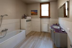 a bathroom with a bath tub and a sink at Italian Vacation Homes - Easy Living Iseo Lake in Predore +37 photos