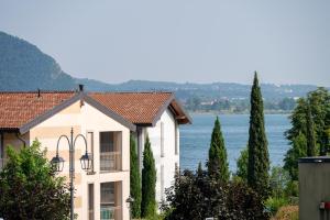 a building with a view of the water at Italian Vacation Homes - Easy Living Iseo Lake in Predore