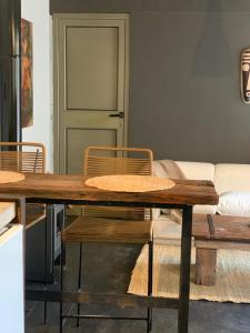 a dining room with a wooden table and chairs at Cabaña del Bosque in Las Calles