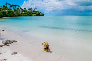 a person in the water on a beach at Cocobay Resort Antigua - All Inclusive - Adults Only in Johnsons Point