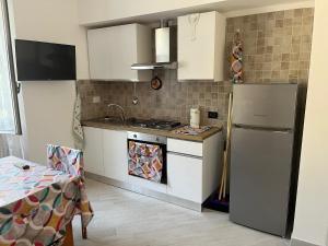 a kitchen with a refrigerator and a stove top oven at Casa Camilli in Genova