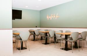 a group of tables and chairs in a room at Hostal Ainhoa in Tafalla