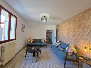 a living room with a blue couch and chairs at Filicaria Gite in Chambon-sur-Voueize