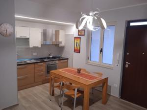 a kitchen with a table and chairs and a clock at Casa Sofia in Agropoli
