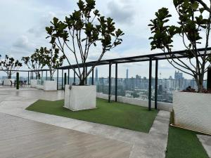 a balcony with trees on top of a building at Skyline Homes by Reizz in Kuala Lumpur