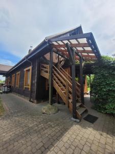 a building with a roof on top of it at Pokoje Gościnne Grzegorz-2 in Białowieża +4 photos
