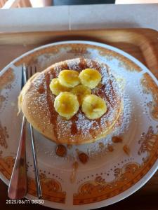 a plate with a pancake with bananas on it at G Lova House -Tetebatu in Tetebatu