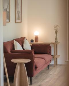 a living room with a couch and a table at The Rising in Tongue +12 photos