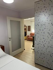 a room with a bed and a door with birds on the wall at Mediterranean house in Skala Sotiros