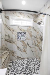 bagno con doccia e parete in marmo di Private House in Heart of Historic Barton Heights! a Richmond Altre 73 foto