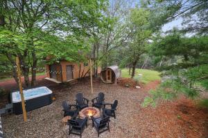 a backyard with a table and chairs and a tent at 4 Br Mtn Cabin Sauna Hot Tub Fire Pit Putt Putt in Albrightsville