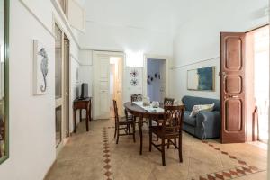 a living room with a table and a couch at Palazzo Caputo in Santa Maria al Bagno