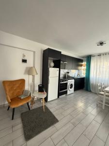a kitchen and living room with a table and a chair at Kypa rooms 50 steps to the beach in Larnaca