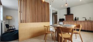a kitchen with a table and chairs in a room at La maison des vignerons - Le Schlossreben in Orschwiller +16 photos