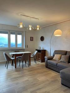 a living room with a table and a couch at Maison Solange Saint Vincent in Saint Vincent