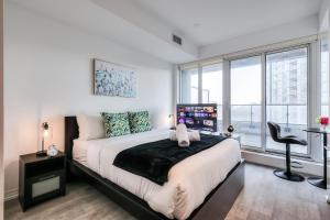 a bedroom with a large bed and a window at RivetStays - The Jarvis in Toronto