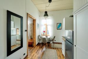 a kitchen with a table and a refrigerator and a window at Your Lutsu Apartment Lux Retro Prime Spot in Viljandi +40 photos