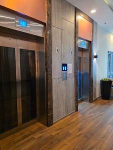 a row of elevators in an office lobby at Lazuli Elegant Studio Condo Unit in Baguio
