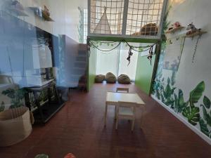 a living room with a table and a fish tank at Lazuli Elegant Studio Condo Unit in Baguio +5 photos