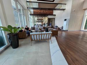 a lobby of a building with people sitting at Lazuli Elegant Studio Condo Unit in Baguio