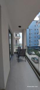 a balcony with a bench in a building with windows at Apartament Derys in Năvodari