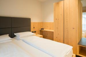 Postel nebo postele na pokoji v ubytování Hotel La Montanara Predazzo