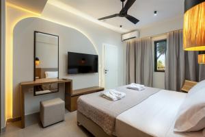 a hotel room with a bed and a mirror at Thalo "Aegean Touch Apartments" in Kardamaina