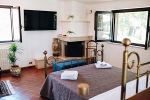 a bedroom with a bed with two white towels on it at Villa Silvana tra natura e mare in Polignano a Mare