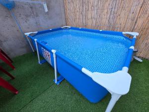 a blue pool with a chair in a room at Apartamento Loft con 2 dormitorios, Jacuzzi y Garage in Cambrils
