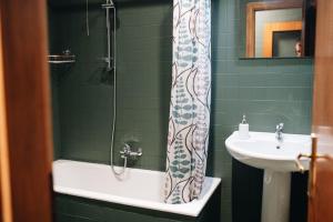 a bathroom with a sink and a shower curtain at Villa Silvana tra natura e mare in Polignano a Mare +24 photos