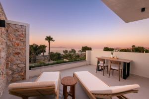 a balcony with a table and a view of the ocean at Thalo "Aegean Touch Apartments" in Kardamaina