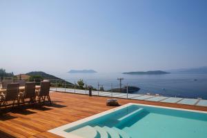 a swimming pool on a deck with a view of the water at 2S Villas Resort - Cave Villas in Sivota
