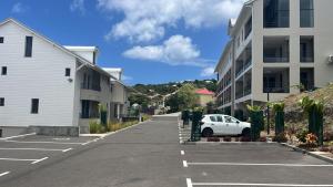 a car parked in a parking lot next to a building at L'Astrolabe in Vieux-Fort