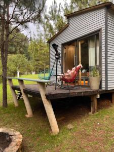 a table with a surfboard on top of a house at Tiny Cozy Cabin las moras in San Mateo Río Hondo
