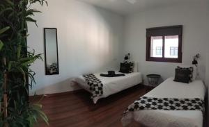 a room with two beds and a mirror at Hotel Masai Mara Resort in San Bartolomé de Tirajana +124 photos