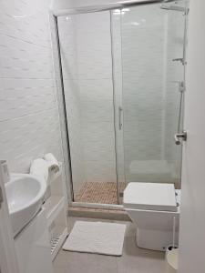 a bathroom with a shower and a toilet and a sink at Casa do Rio - Apartment Earth in Portimão