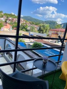 a balcony with a table and a view of a pool at Hotel Bosna in Kladanj +46 photos