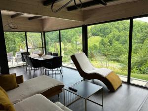 a living room with a couch and a table at Cabanele din Valea Ursului in Bîrsana